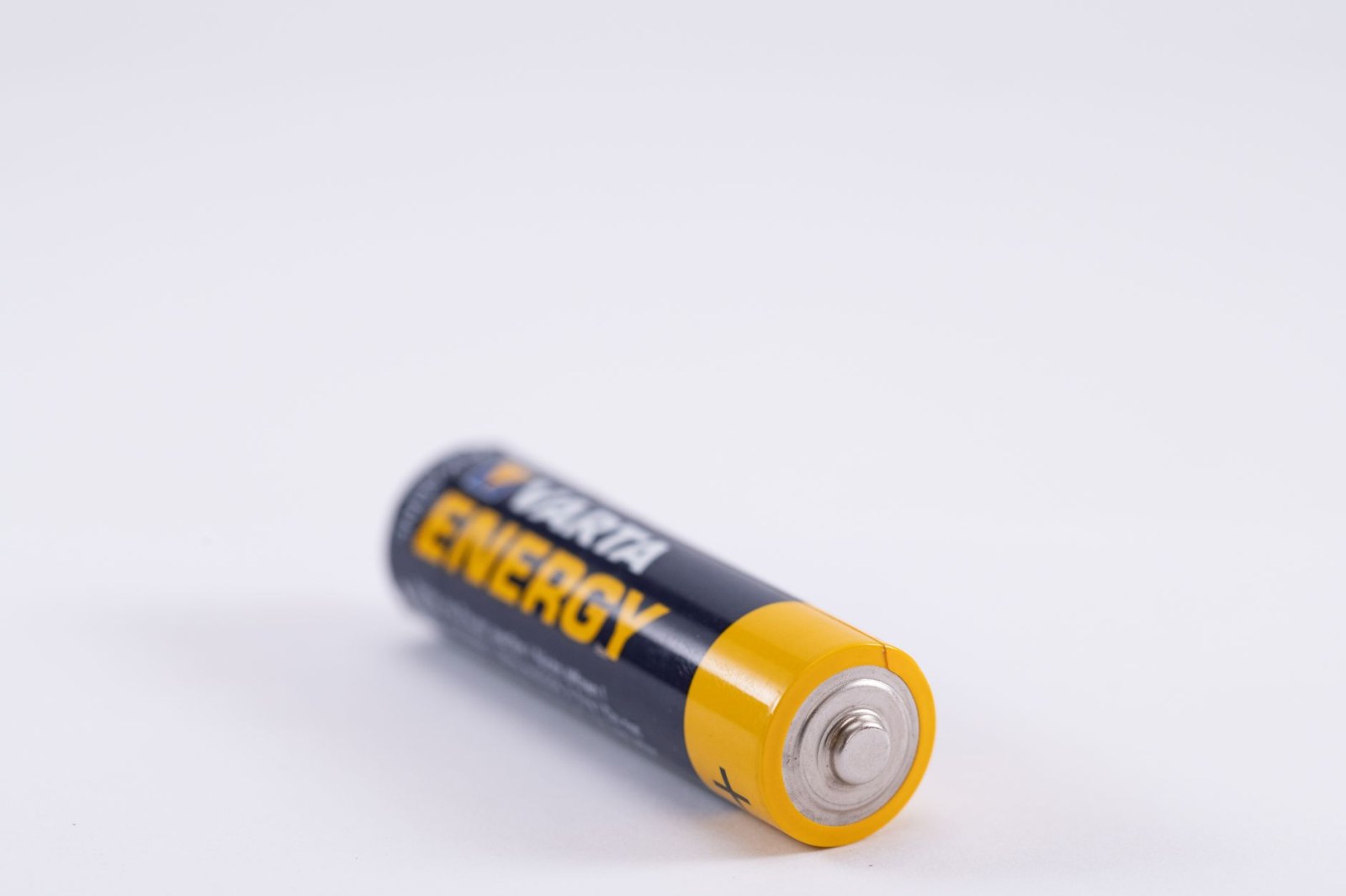 Primo piano dettagliato di una pila AA Varta Energy su sfondo bianco.